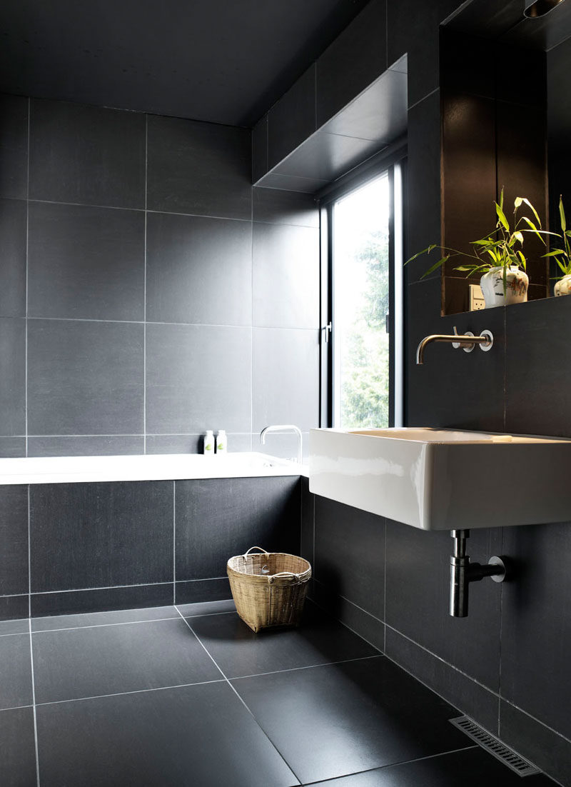 Bathroom Tile Ideas - Use Large Tiles On The Floor And Walls // The use of white grout around these large dark tiles works well because the grout doesn't take over the bathroom - the tiles are large enough to use such contrasting materials without it looking busy or overwhelming.
