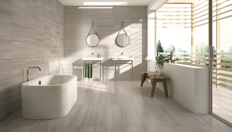 Bathroom Tile Ideas - Use Large Tiles On The Floor And Walls // Large light colored matching tiles on the floor and walls of this bathroom make the space feel modern and bright.