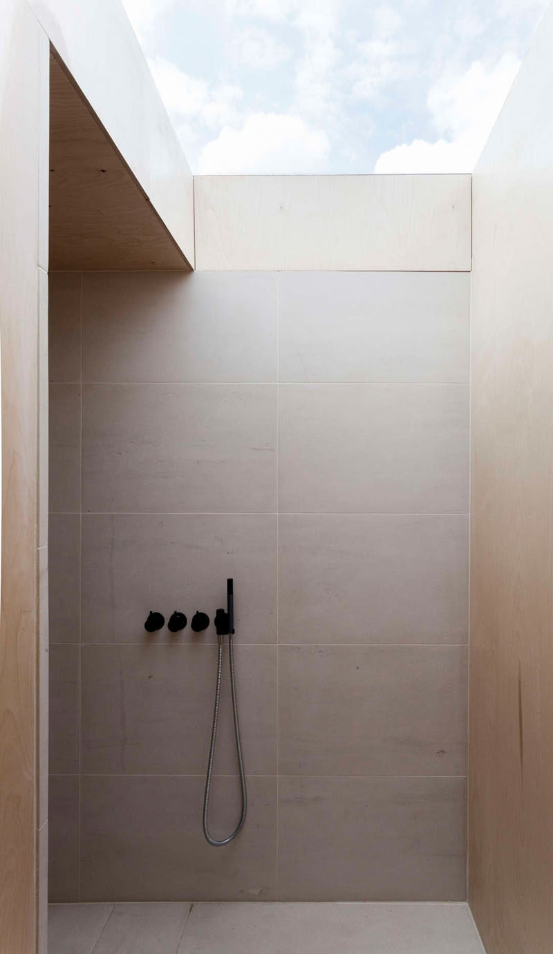 Bathroom Tile Ideas - Use Large Tiles On The Floor And Walls // The large tiles on the wall of this bathroom shower help make the space feel open, while the light color of them reflects the natural light helping to keep the shower area bright.