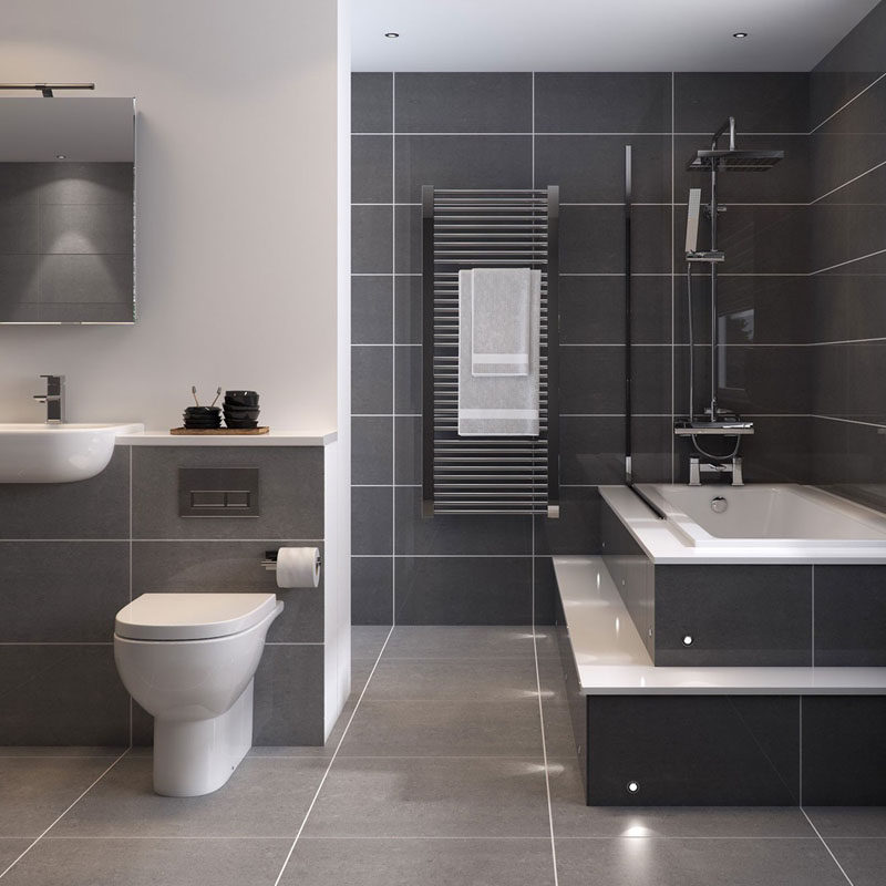 Bathroom Tile Ideas - Use Large Tiles On The Floor And Walls // Large dark grey tiles surrounded by white grout and white appliances makes this bathroom look clean, sleek, and relaxing.