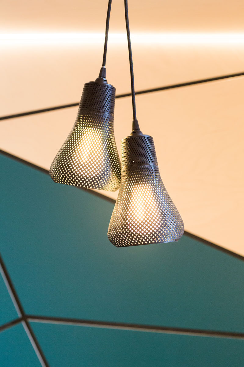 The lights hanging above the tables in this cafe are pairs of Kayan pendants from Plumen.
