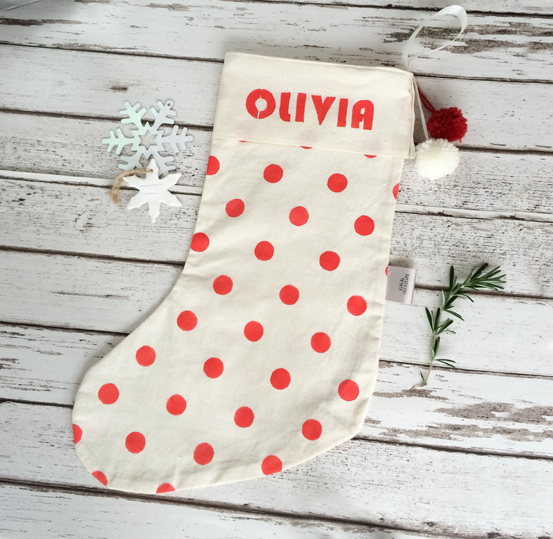 30 Modern Christmas Decor Ideas For Your Home // A simple cotton stocking personalized with polka dots and a name is a fun way to create a family mantle with no fear of confusion on Christmas morning.