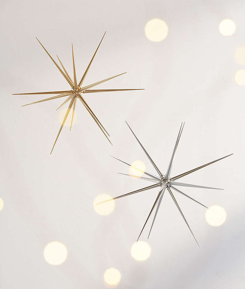 30 Modern Christmas Decor Ideas For Your Home // Hang a few of these silver and gold stars in your windows to create a festive, modern window display.