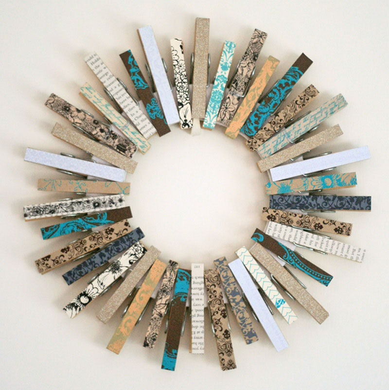 21 Modern Wreaths To Decorate Your Home With This Holiday Season // Decorate a circle with colorful clothes pins to create a simple, festive piece of decor.