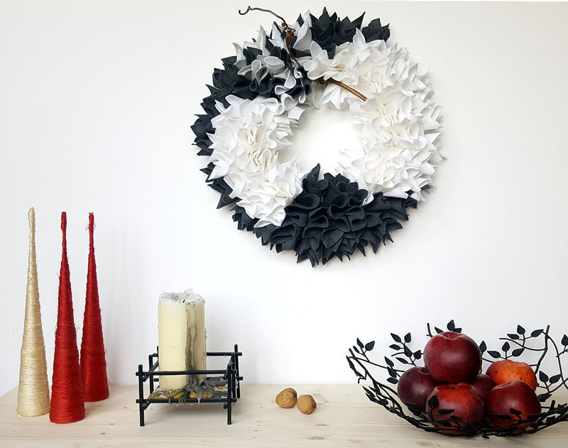 21 Modern Wreaths To Decorate Your Home With This Holiday Season // Bunches of grey and white felt give this monochrome wreath a textured look and a festive feel.