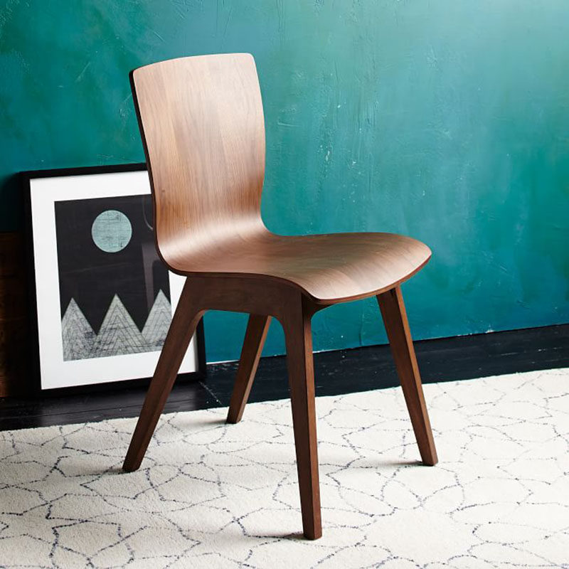 Furniture Ideas - 14 Modern Wood Chairs For Your Dining Room // The smooth curves of this dark wood chair make it a comfortable place to sit and eat and chat with friends and family.