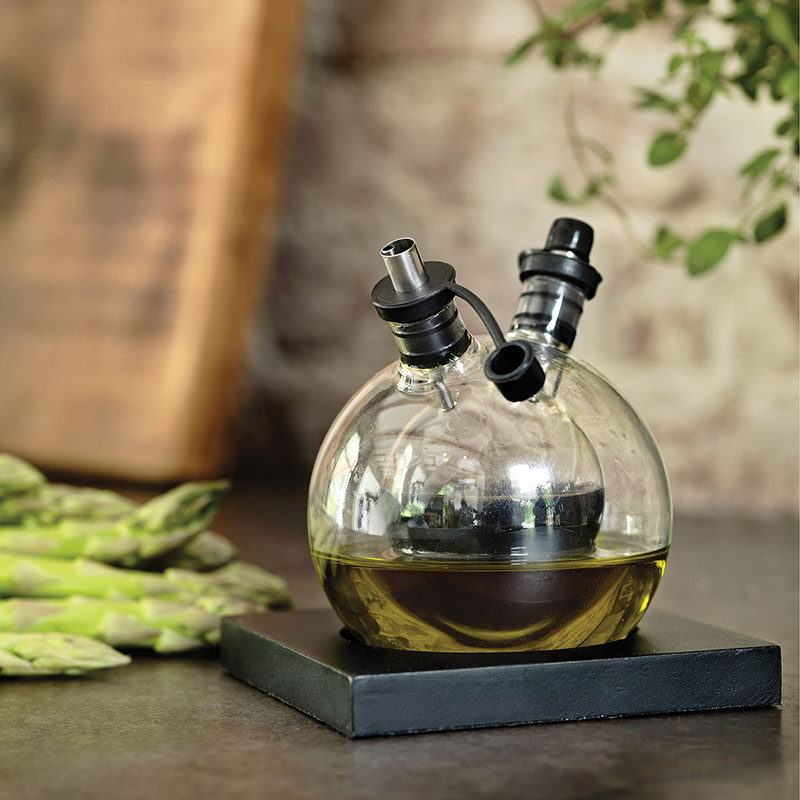 Essential Kitchen Tools - 11 Creative Oil & Vinegar Dispensers // This circular oil and vinegar set comes with a little base to help keep it upright and on display.