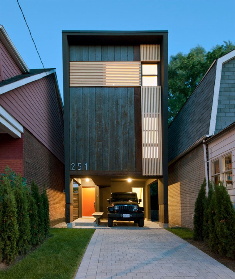 11 Small Modern House Designs // This narrow house fits tightly between the two houses on either side of it and makes up for it's narrow width by being slightly taller than the other houses around it.