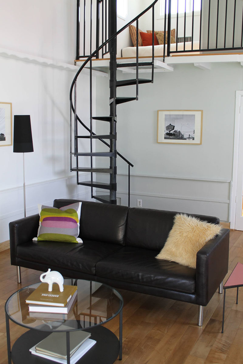 13 Stair Design Ideas For Small Spaces // The thin spiral staircase leading up to the bedroom of this house compliments the other black elements in the home and takes up very little space.