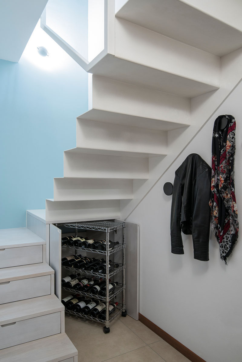 Stairs Design Idea - Hide Shoe And Wine Storage Within Your Stairs // Under the landing of this staircase two doors open up to reveal a storage cupboard that is just the right size to fit a wine cart stocked with all your favorite bottles of wine.