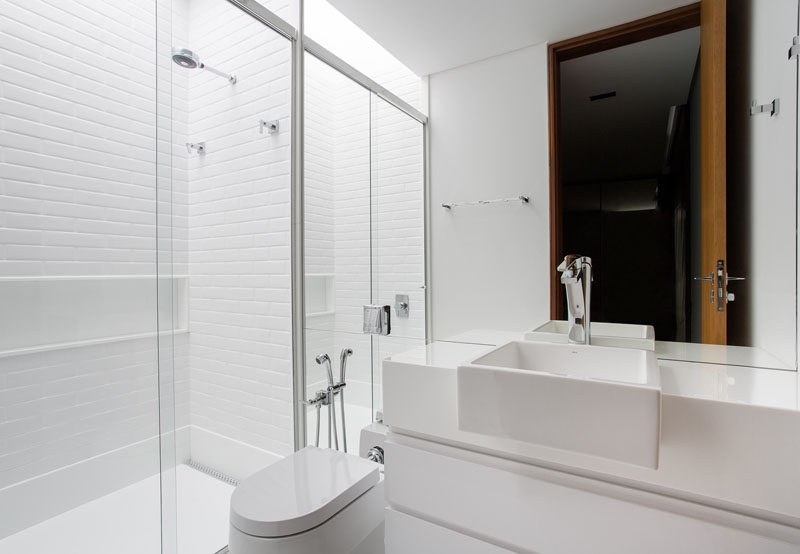 This white bathroom is just that, an almost pure white bathroom, with white vanity, white tiles and white toilet.