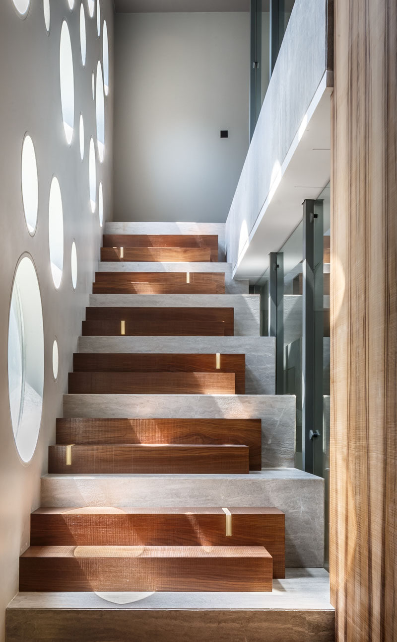 The design of these stairs combines wooden steps with a concrete base, and LED strips add some discreet lighting.