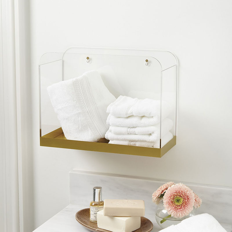 5 Ways To Use Acrylic Decor Throughout Your House // Bathroom - A gold bottom on this acrylic wall bin gives it an elegant look while still keeping it simple and stylish.