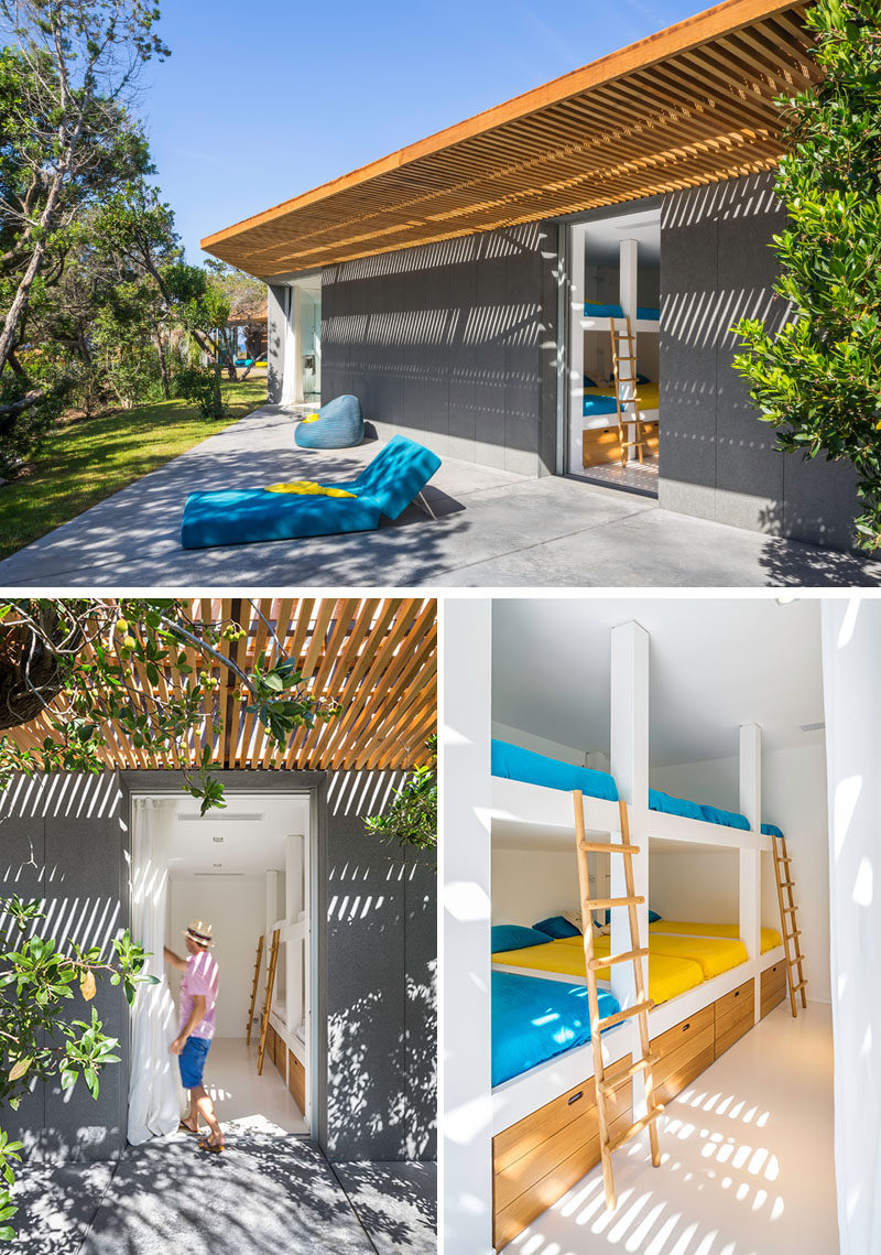This modern villa has a bedroom filled with bunk beds and additional storage.