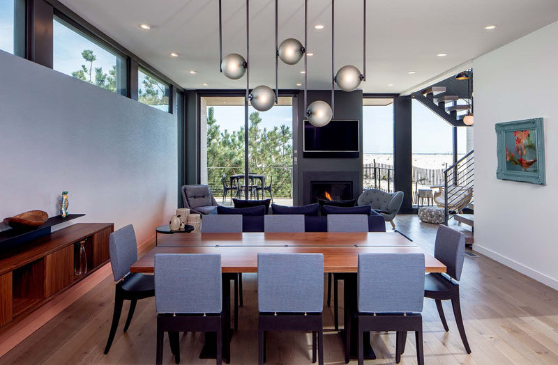 Above this dining table, a sculptural lighting fixture by Ladies and Gentlemen Studio, anchors the dining table in the open floor plan.
