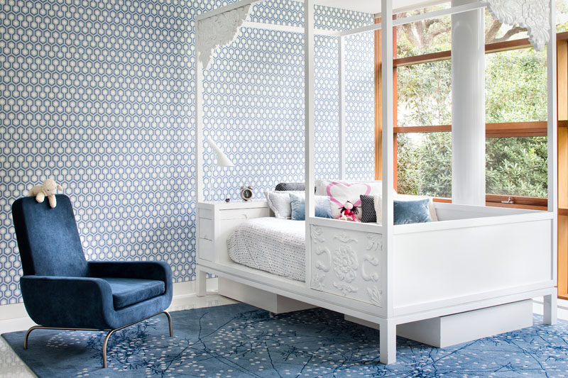 Playful patterned wallpaper covers the wall in this children's bedroom.