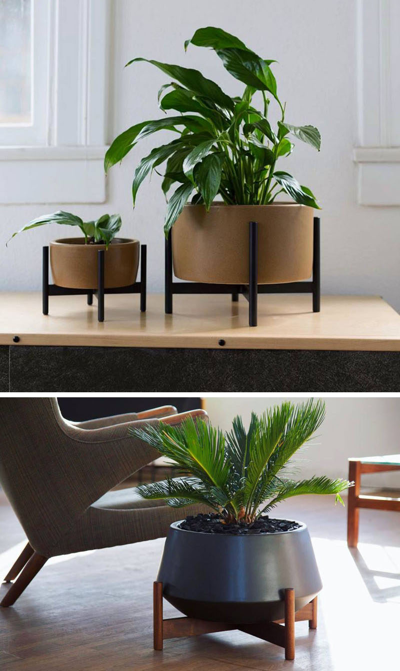 Home Decor Ideas - 6 Ways To Include Ceramic In Your Interior // These ceramic planters with wooden stands combine two natural elements and create a modern place to display your plants.