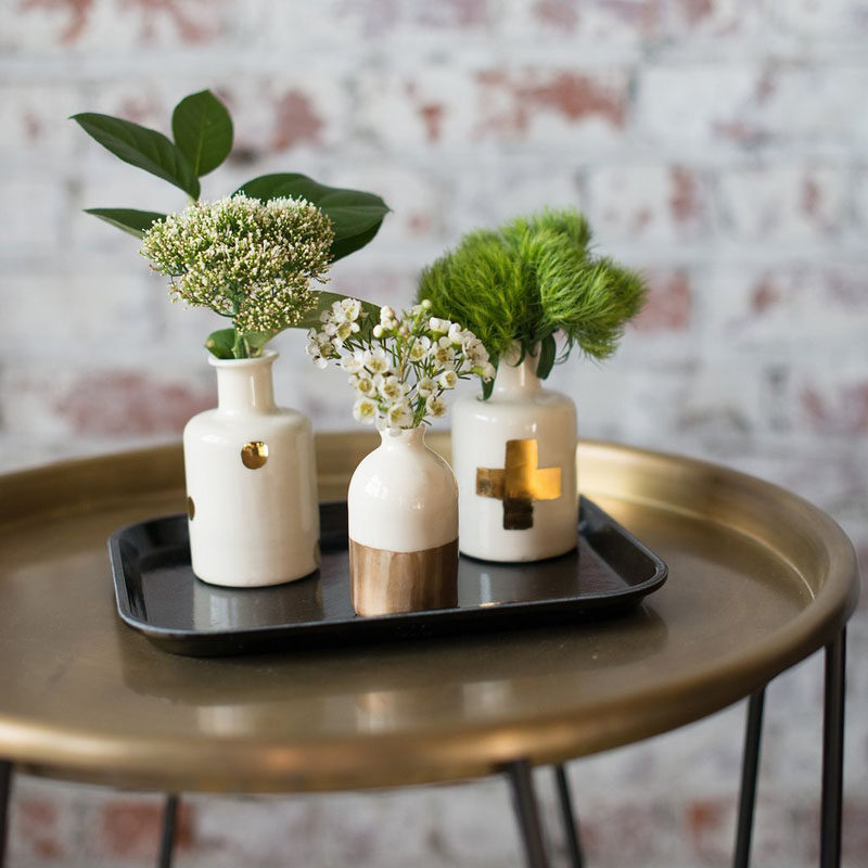 Home Decor Ideas - 6 Ways To Include Ceramic In Your Interior // Small bud vases like these white and gold ones are great for putting wild flowers or small branches in to liven up your space.
