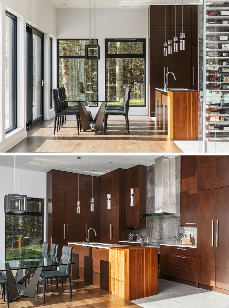 This dining area and kitchen both share the same space, with the kitchen cabinets reaching all the way to the high ceiling.