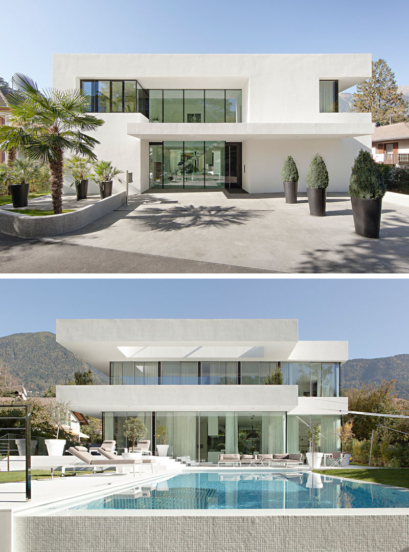House Exterior Colors - 11 Modern White Houses From Around The World // Walls of windows break up the all white exterior of this modern family home.