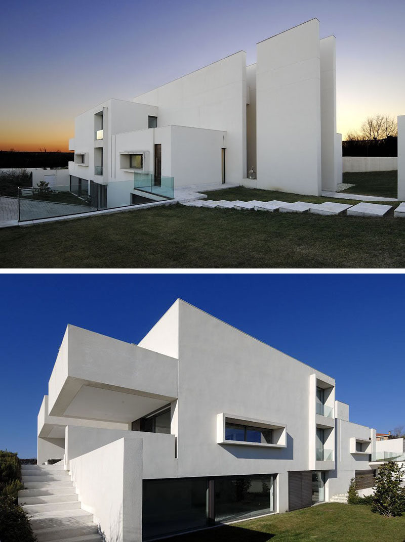 House Exterior Colors - 11 Modern White Houses From Around The World // Large white walls appear to cut through this large modern home dividing it into a number of white rectangles.