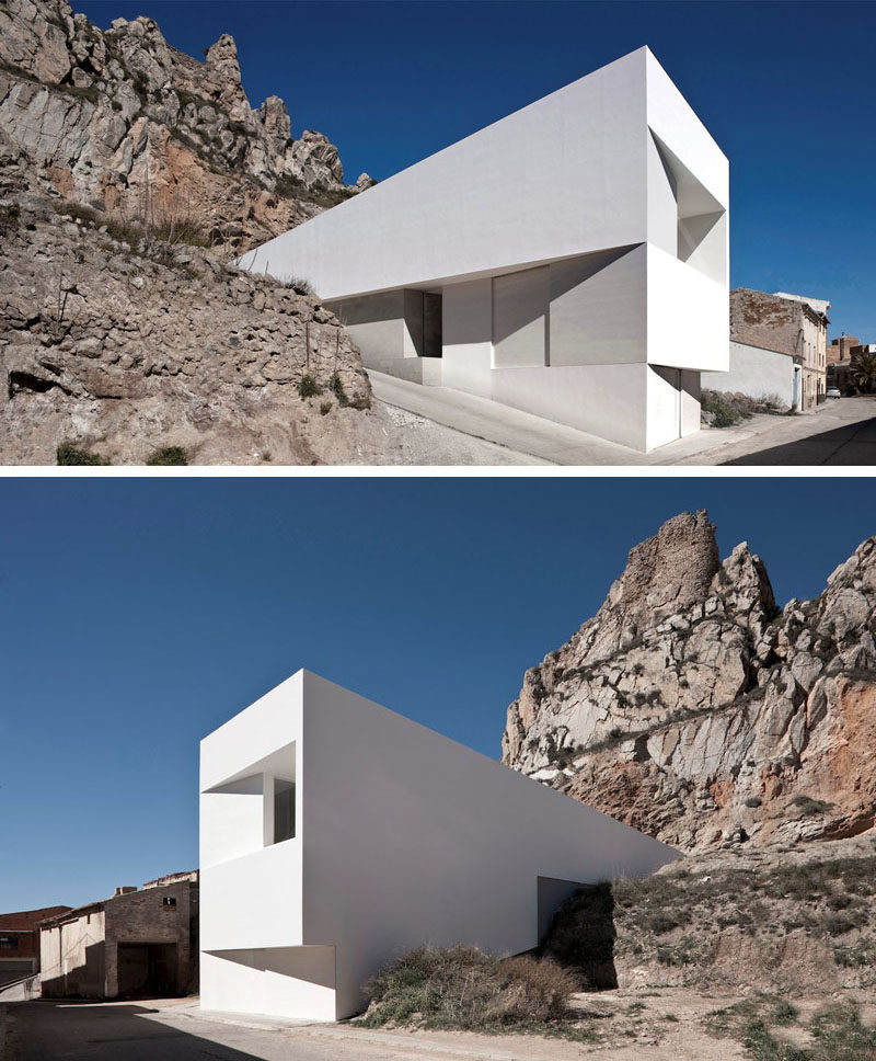 House Exterior Colors - 11 Modern White Houses From Around The World // This large, white, rectangular house appears to be emerging right out of the rocks from the mountain behind it.