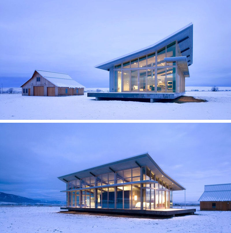 16 Examples Of Modern Houses With A Sloped Roof | The sloped roof on this modern glass farmhouse mimics the look of half of the barn behind it.