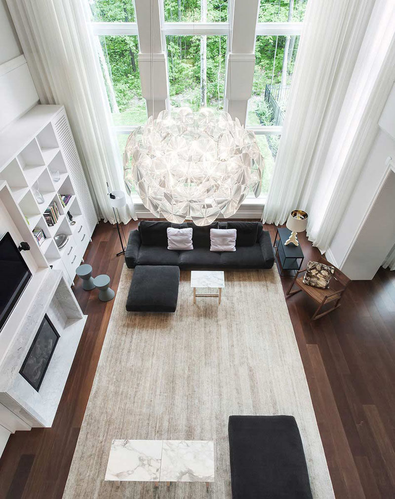Interior Design Ideas - 17 Modern Living Rooms As Seen From Above | The dark wood floors of this living room are brightened up by the tall windows and large light colored rug.