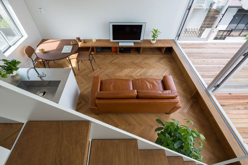 Interior Design Ideas - 17 Modern Living Rooms As Seen From Above | Various shades of brown give this living space a more natural feel that's accentuated by the plants and wood elements.
