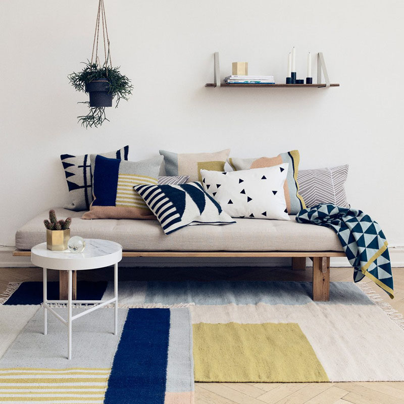 4 Ways To Use Navy Home Decor To Create A Modern Blue Living Room // Curtains, an area rug, throw pillows, and wall art are just a few of the ways you can add touches of navy to your space without the color feeling too dark or dominating.