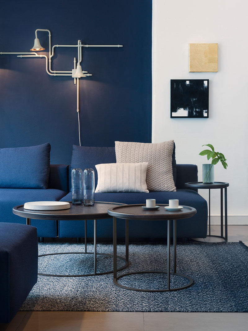 4 Ways To Use Navy Home Decor To Create A Modern Blue Living Room // If you really want to commit to the navy blue color scheme, take the plunge and paint your walls. 