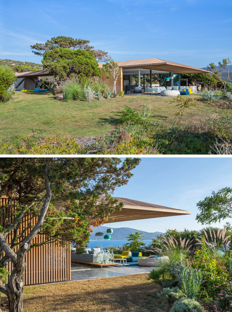 At one end of this villa, there's an outdoor living room receives shade from the extended roof.