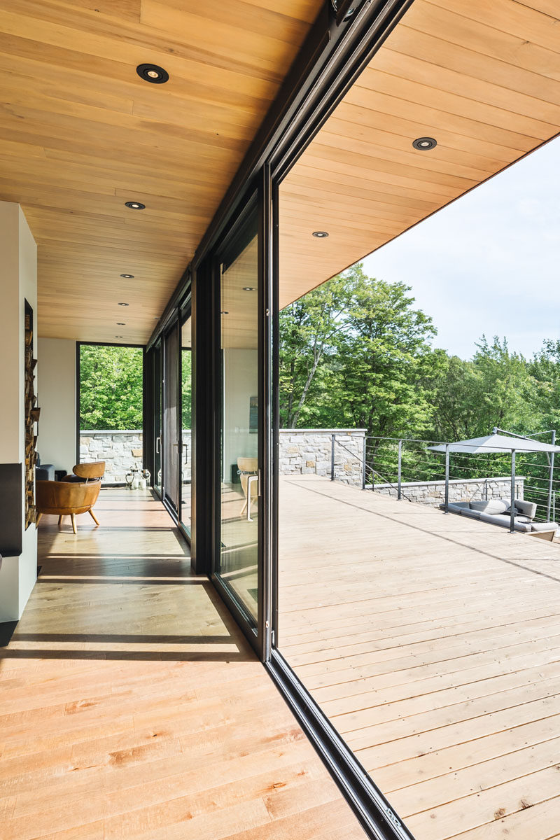 In this contemporary Canadian home, both the living room and the kitchen have access to the deck outside, making it easy to enjoy indoor/outdoor living during the warmer months.