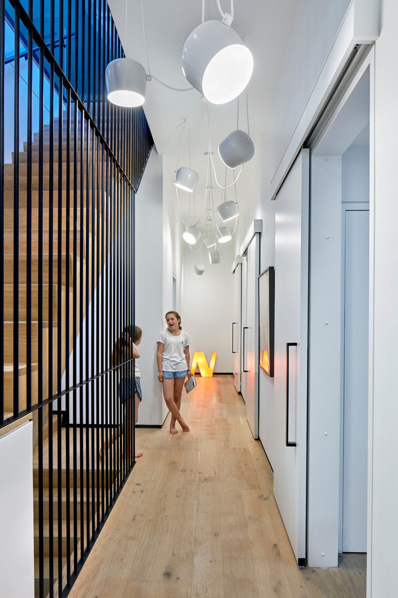 These three kids bedrooms are each accessed by identical sliding doors. Hanging fun white lights make sure the hallway is bright.