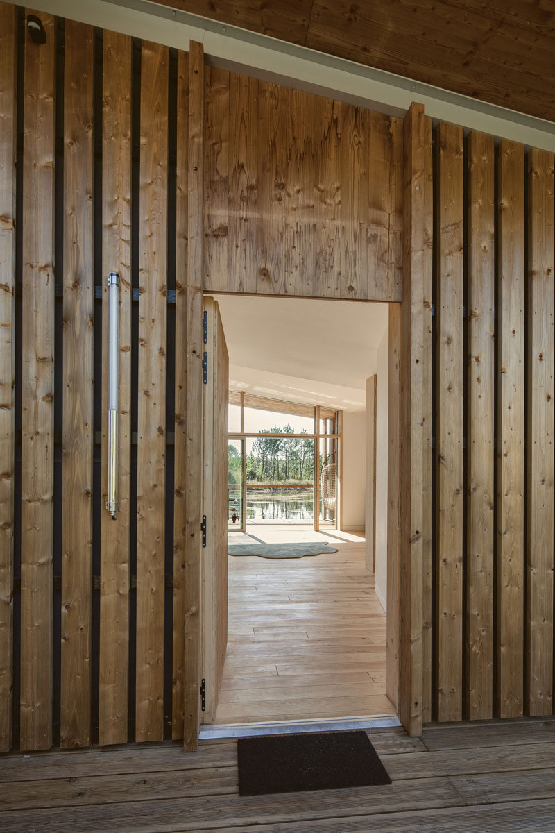 A wooden covered entrance to a villa at an eco-resort in France.