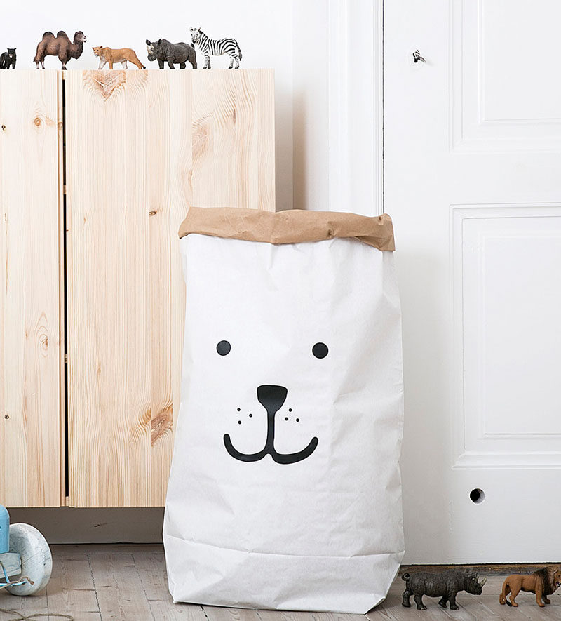 15 Decor Ideas For Creating A Woodland Nursery Design // Toys, blankets, books, dirty clothes, and other things can get overwhelming fast. A large paper bag with a friendly animal face on it can help keep things under control.