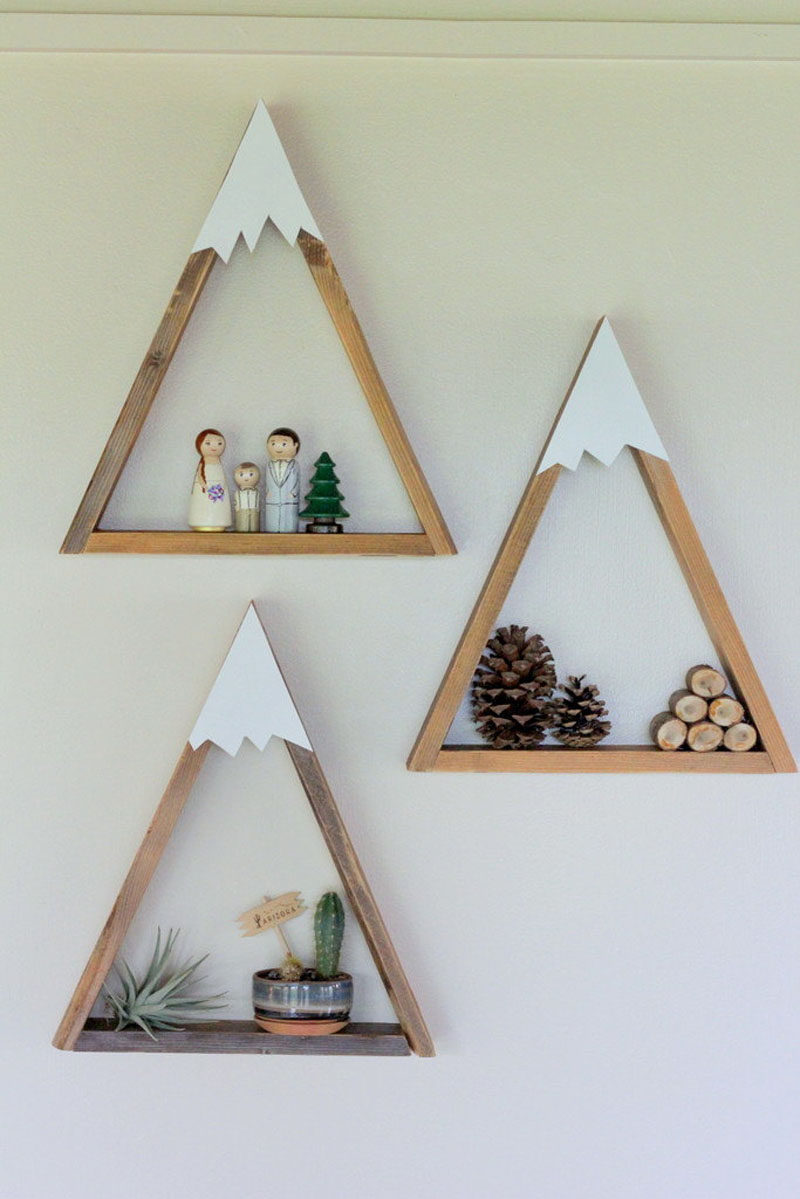 15 Decor Ideas For Creating A Woodland Nursery Design // These mountain shelves are a fun way to put a twist on a regular triangle shelf and create the perfect modern woodland shelving solution.