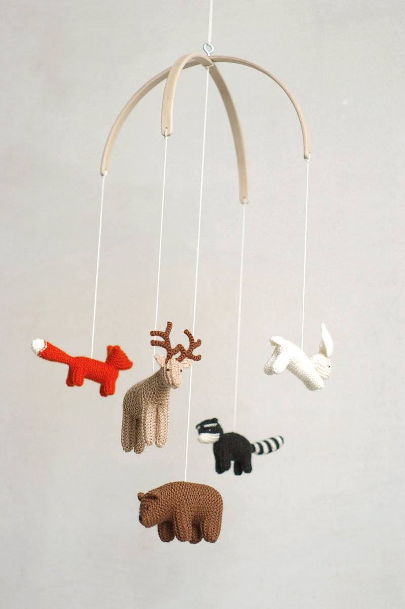15 Decor Ideas For Creating A Woodland Nursery Design // A mobile made from tiny knit animals will keep your baby entertained and tie in with the rest of the woodland pieces you've included in the nursery.