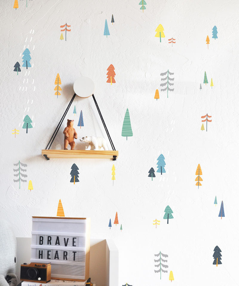 15 Decor Ideas For Creating A Woodland Nursery Design // Small colorful tree wall decals create a more subtle but equally as adorable woodland setting.