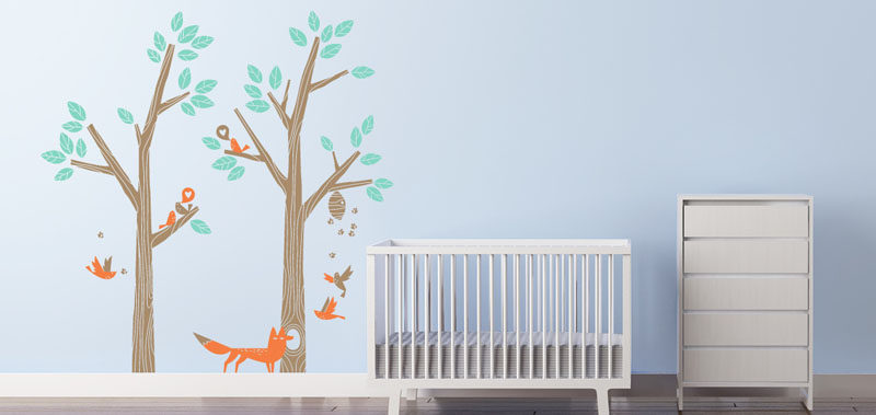 15 Decor Ideas For Creating A Woodland Nursery Design // Create a woodland setting using wall decals with trees, birds, and animals.
