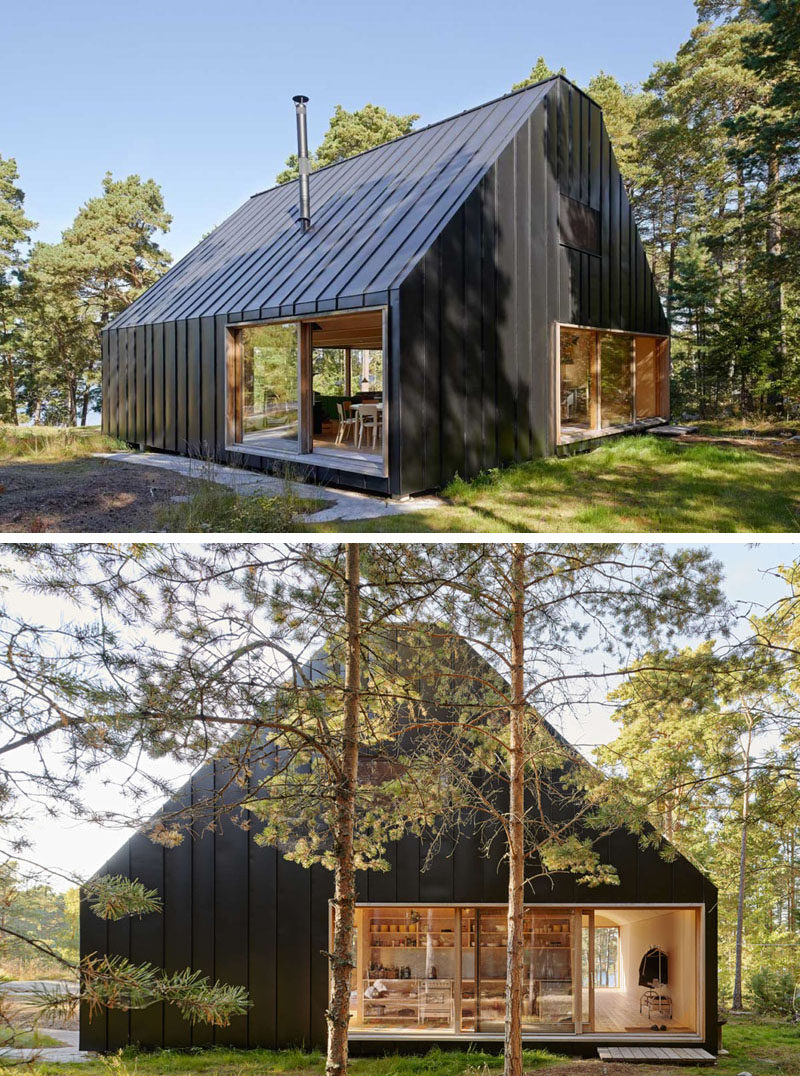 19 Examples Of Modern Scandinavian House Designs | The black siding seamlessly connects with the black roof to create a striking look against the green forest surrounding it.