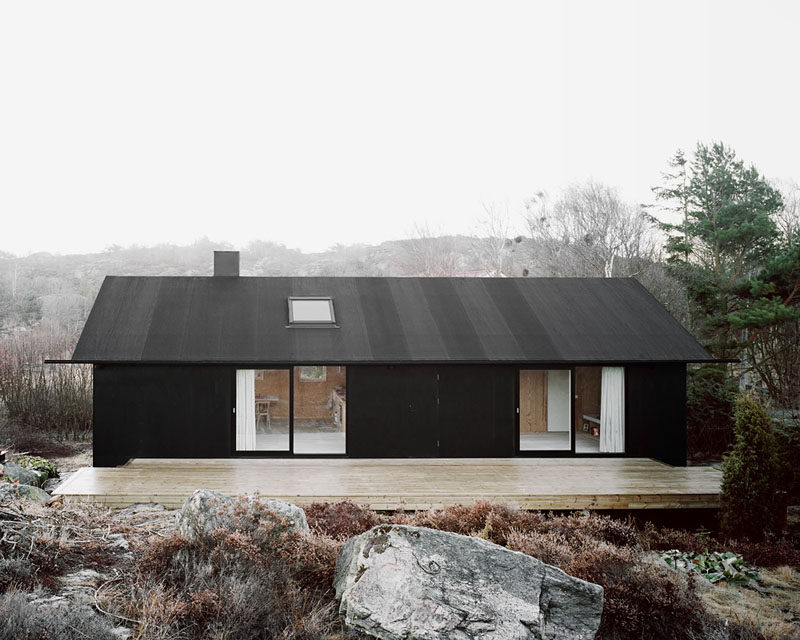 19 Examples Of Modern Scandinavian House Designs | The all black exterior of this simple home gives it a modern look and helps it stand out from its surroundings.